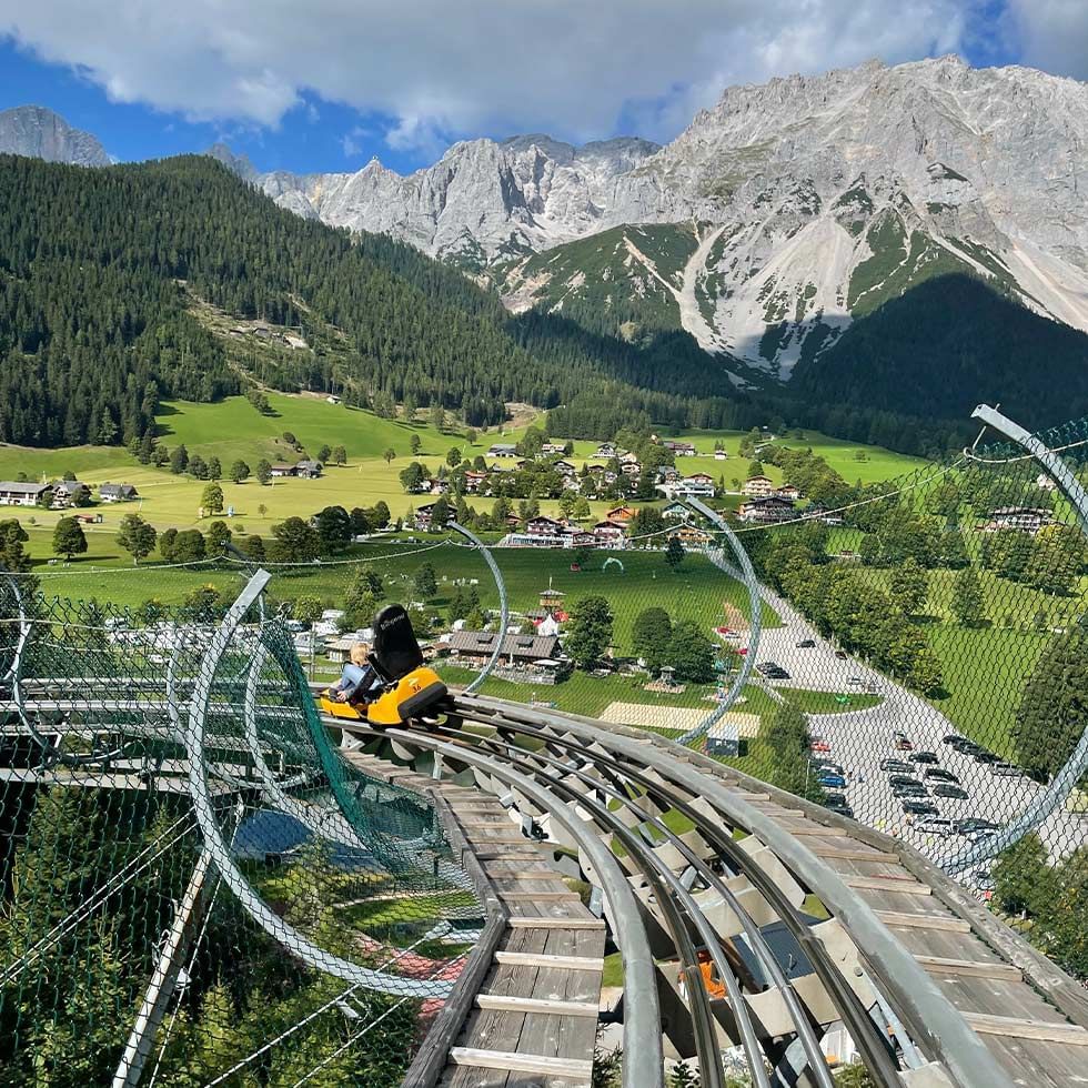 Rittisberg in Austria - a view from the top of a mountain with a train going through it.