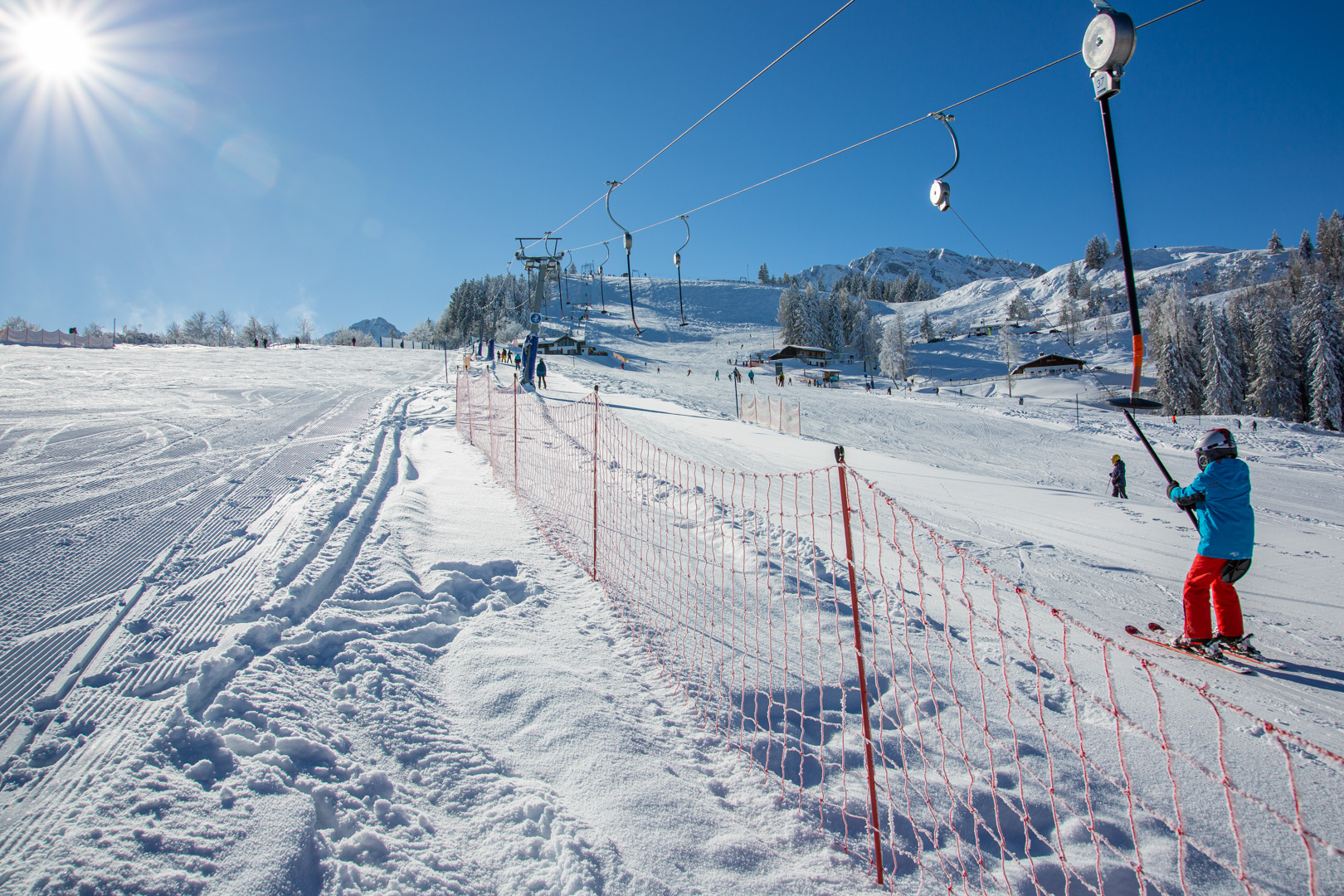 Rossfeld – Berchtesgaden-Oberau in Germany - a person riding a snowboard down a snowy slope.