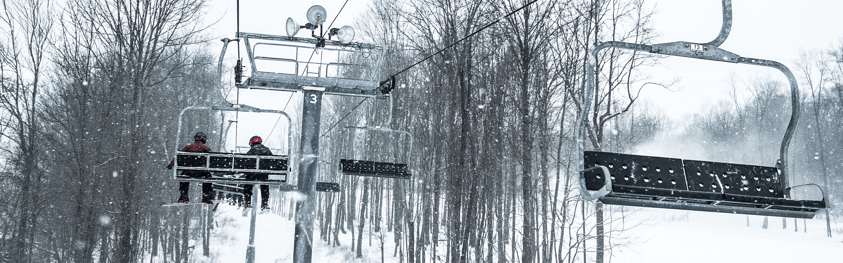 Alpine Valley Ohio in USA - a person riding a ski lift in the snow.