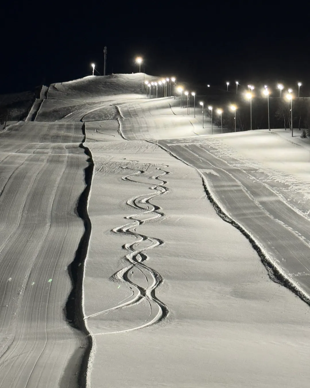Sollifjellet in Norway - a ski slope covered in snow at night.