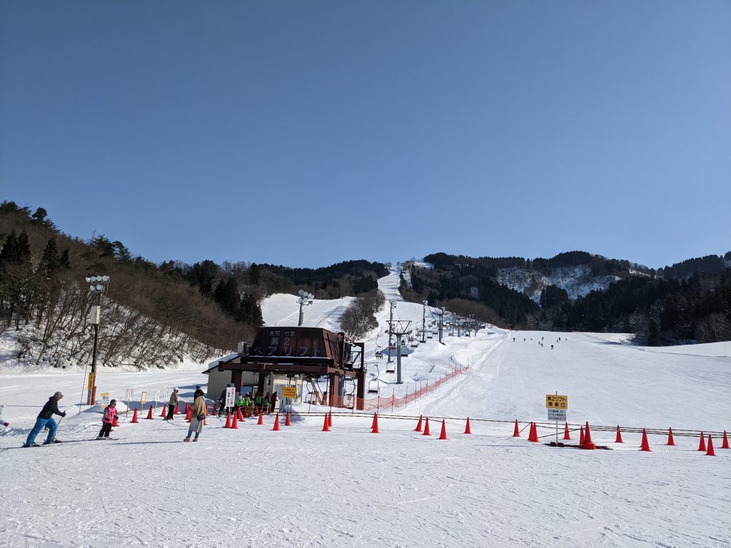 Nagaoka Shiei in Japan - a group of people riding ski boards on a snowy slope.