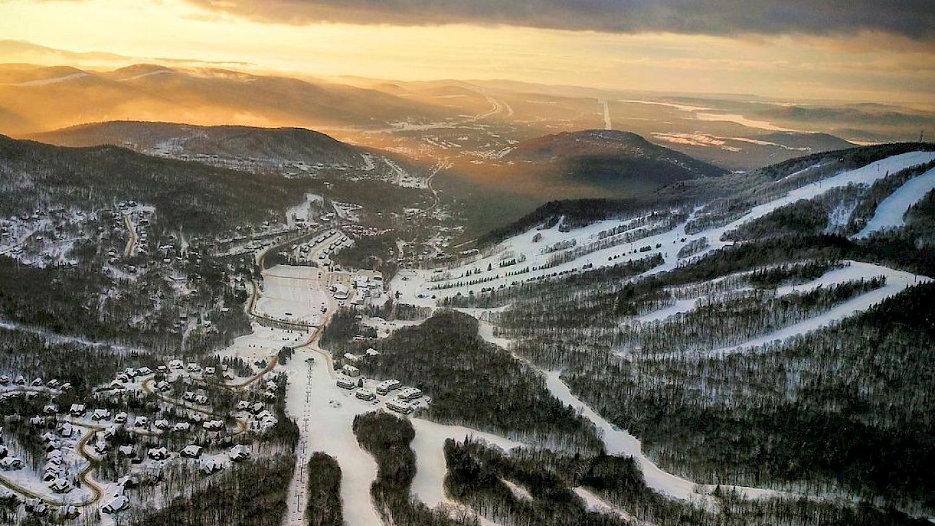 Stoneham in Canada - a view from the top of a mountain at sunset.