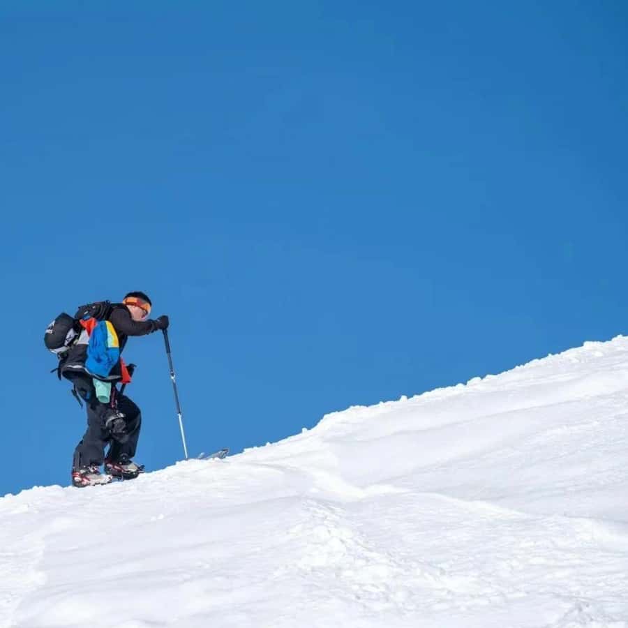 General's Mountain – Altay in China - a person is skiing down a snowy hill.