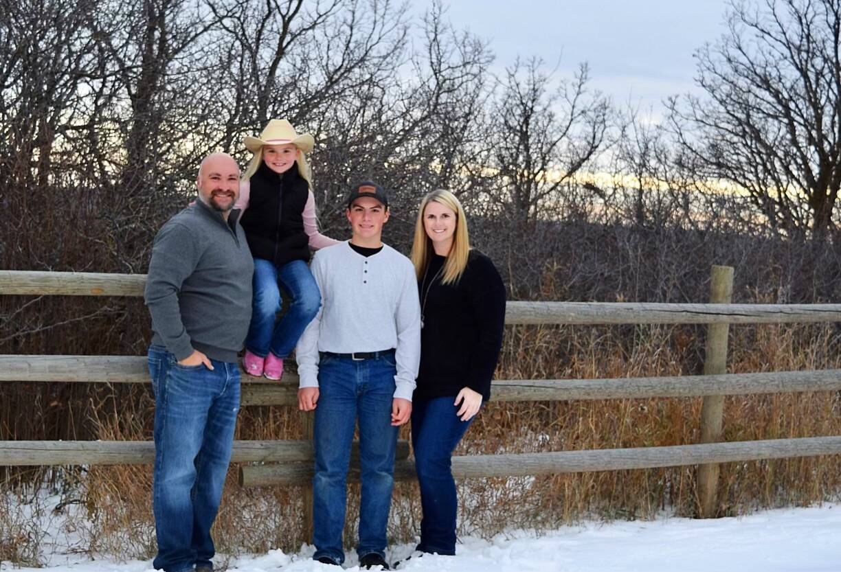Minnedosa Ski Valley in Canada - a family poses for a photo in the snow.