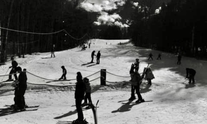 Campton Mountain in USA - a group of people skiing down a snow covered slope.