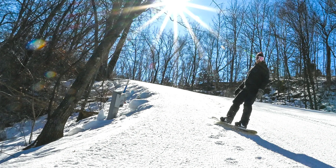Christmas Mountain in USA - a person on a snowboard in the snow.