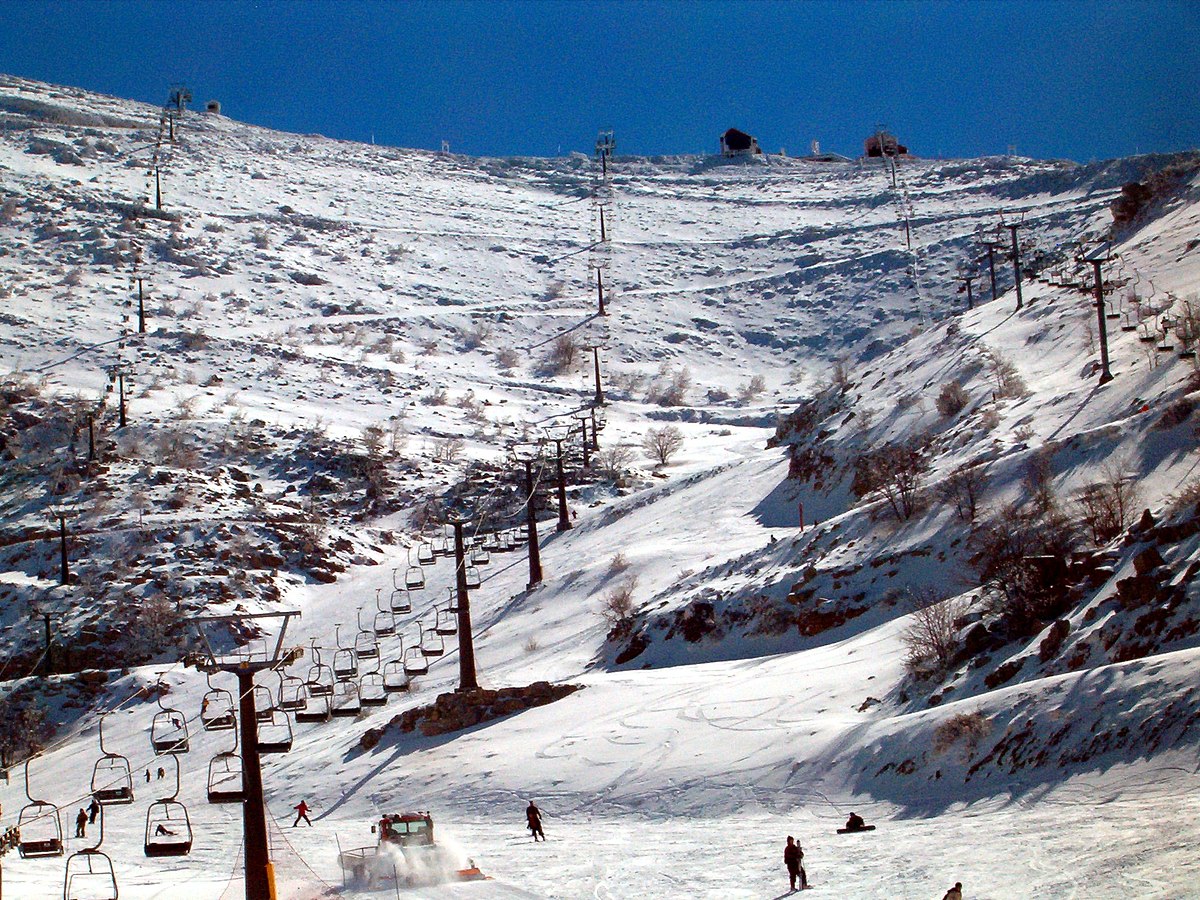 Hermon Mountain in USA - a group of people skiing down a snowy slope.