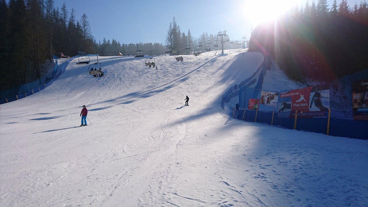 Suche in Poland - a person on a snowboard going down a hill.
