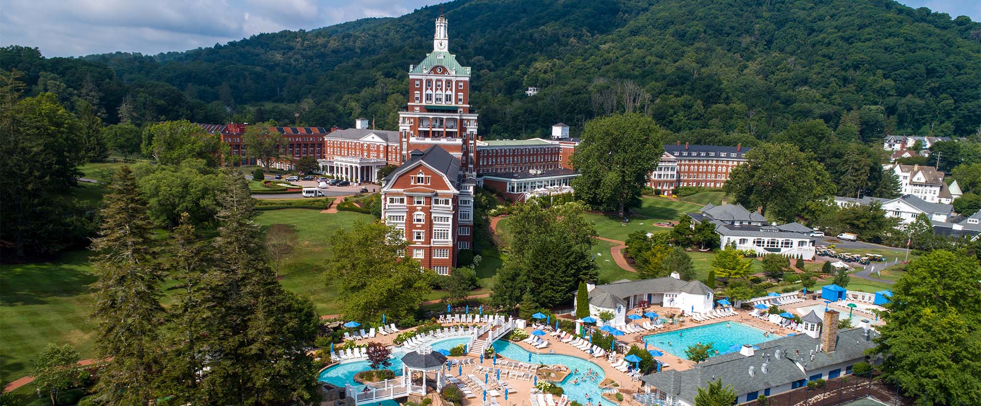 The Omni Homestead in USA: an aerial view of a resort with a swimming pool.