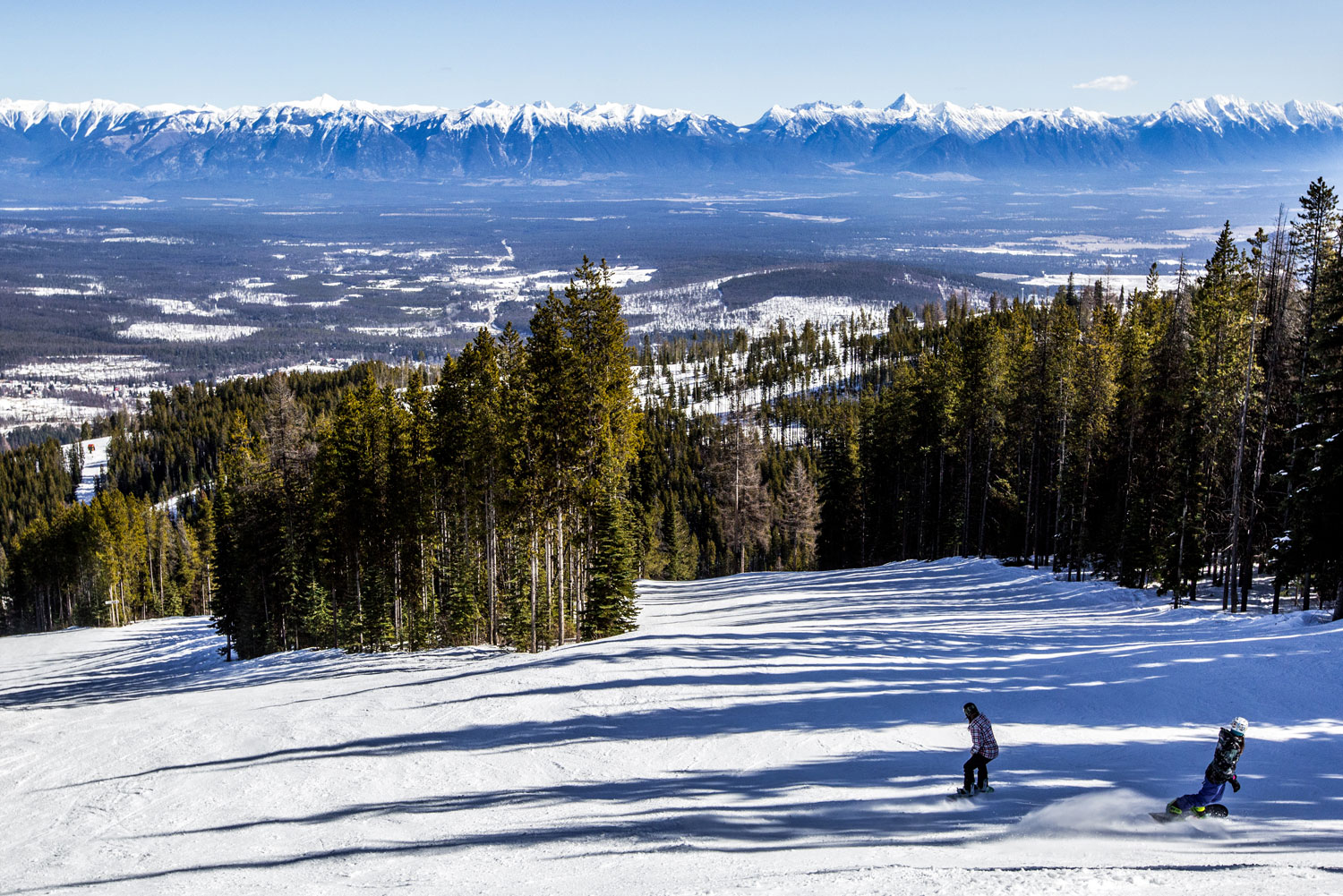 Kimberley in Canada - a person riding a snowboard down a snowy slope.