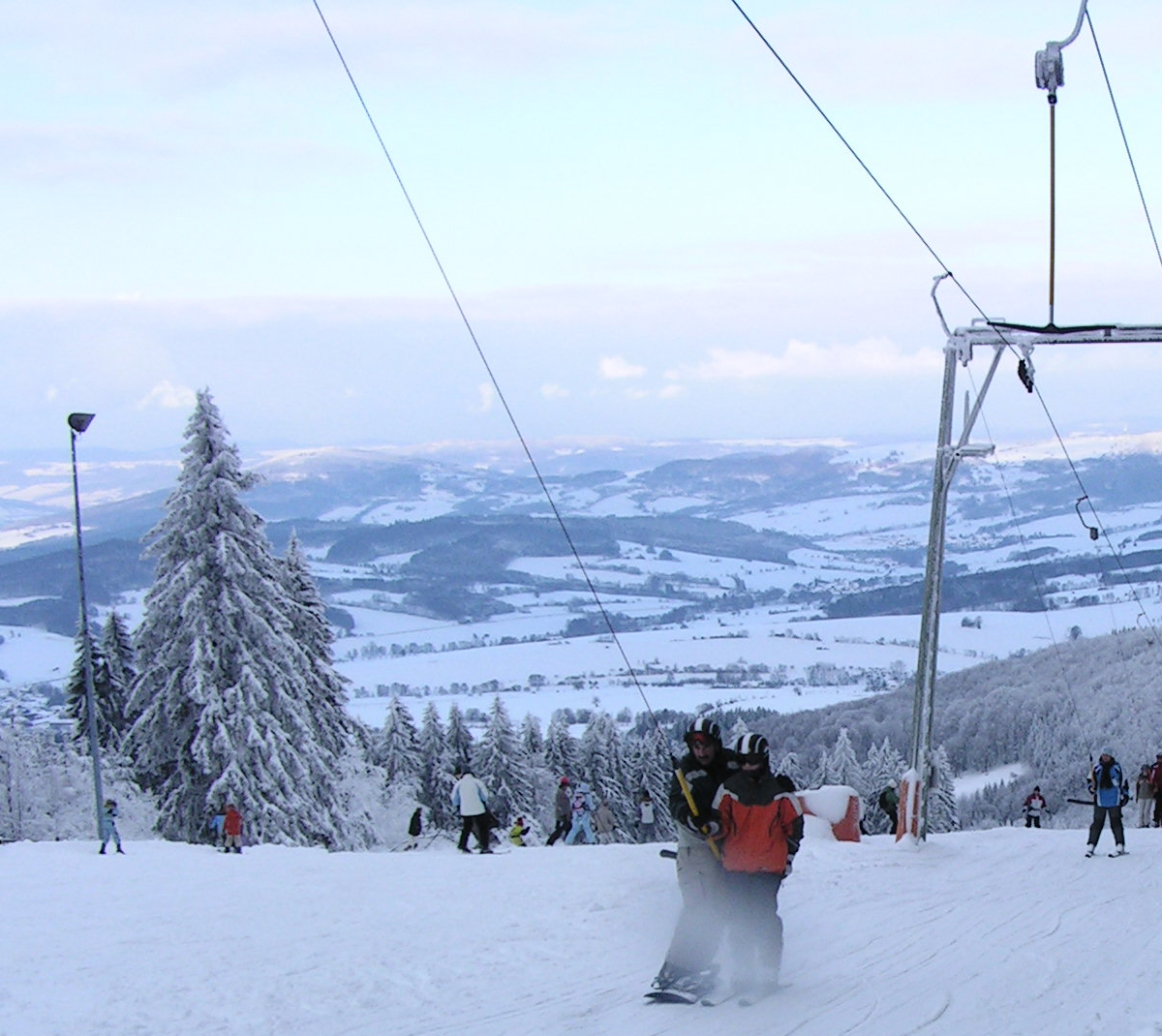Wasserkuppe in Germany - a group of people skiing down a snowy hill.