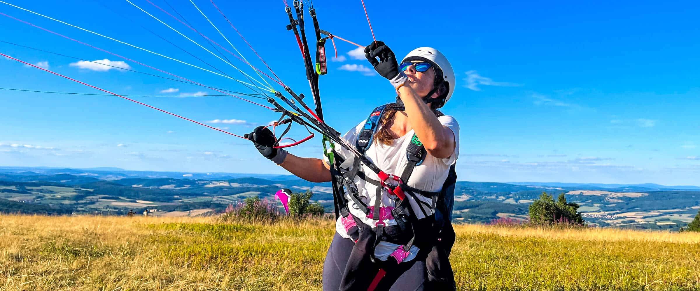Wasserkuppe in Germany - a woman is flying a kite in the air.