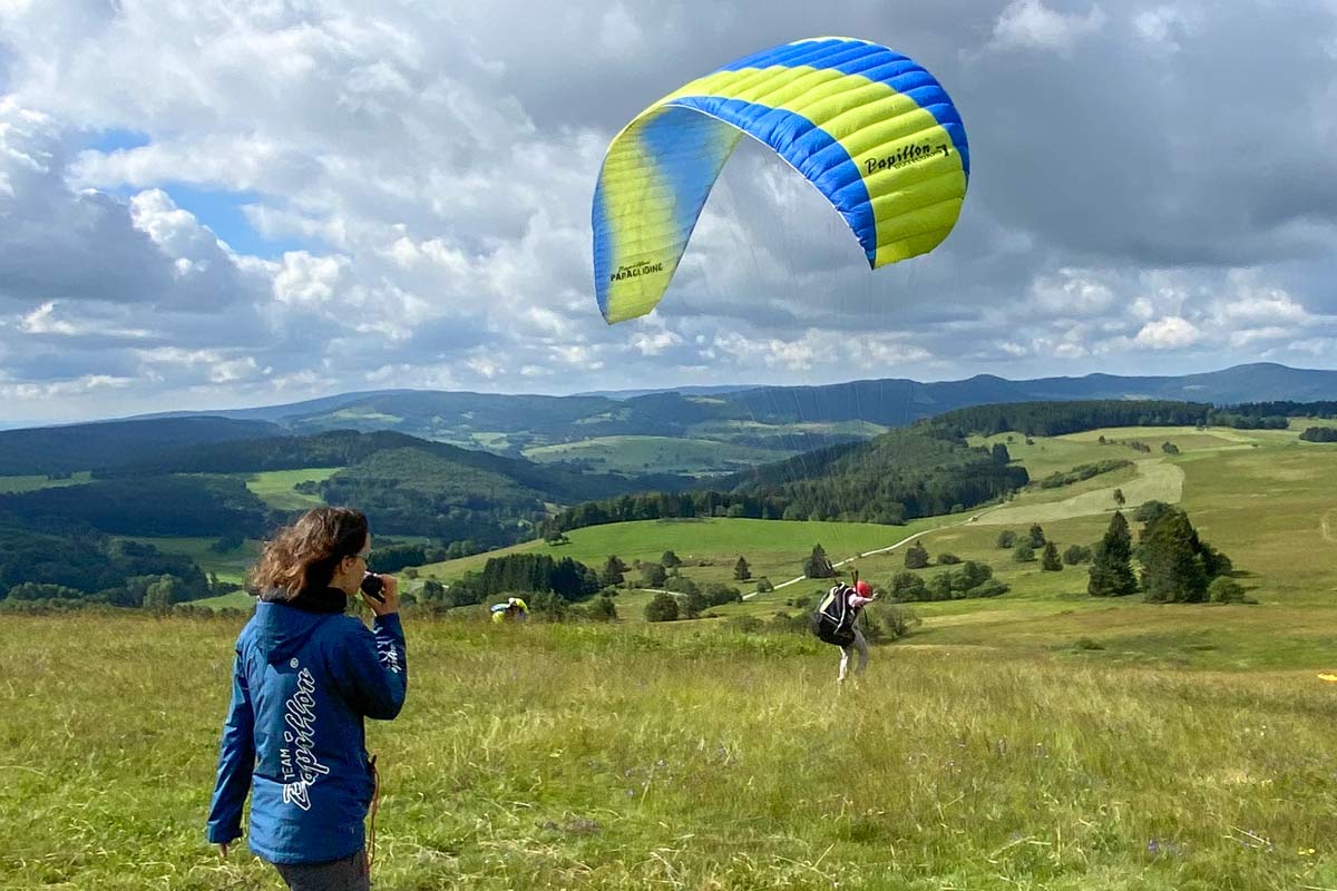 Wasserkuppe in Germany - a person flying a kite in a field.