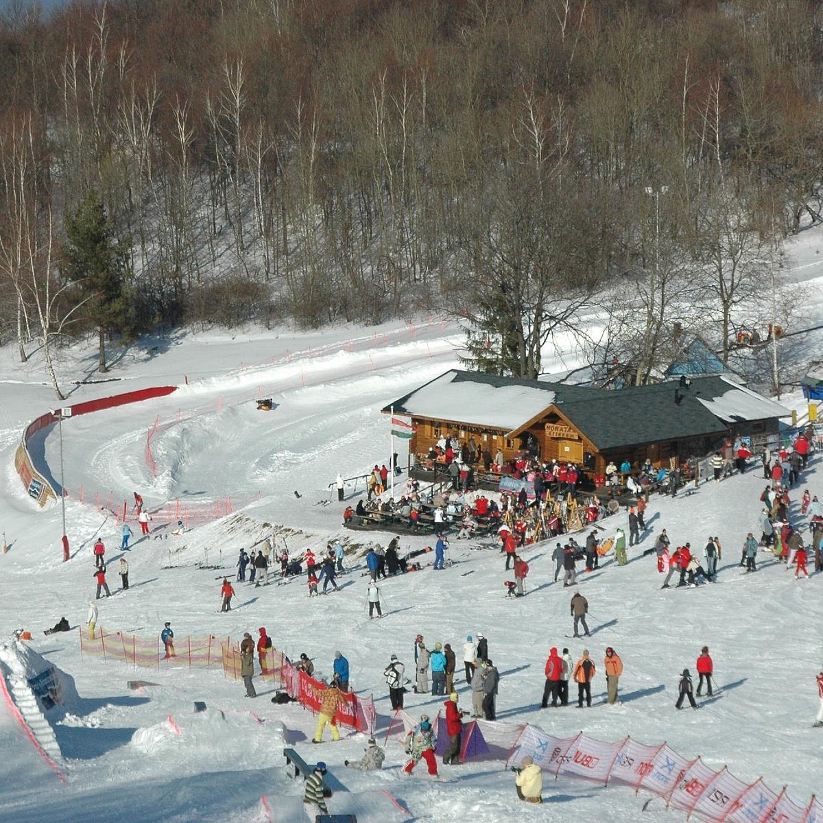 Mátraszentistván Sipark in Hungary - a large group of people skiing down a slope.