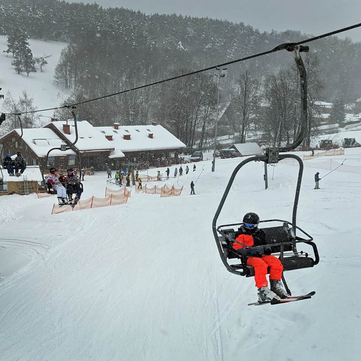 Kiczera – Puławy in Poland - a person riding a ski lift in the snow.
