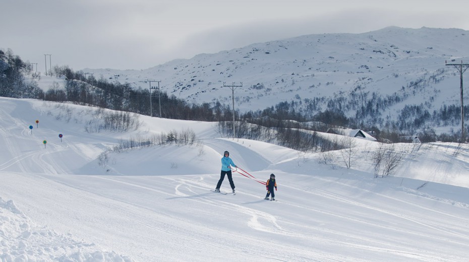 Fidjeland in Norway - a person is skiing down a snowy hill.