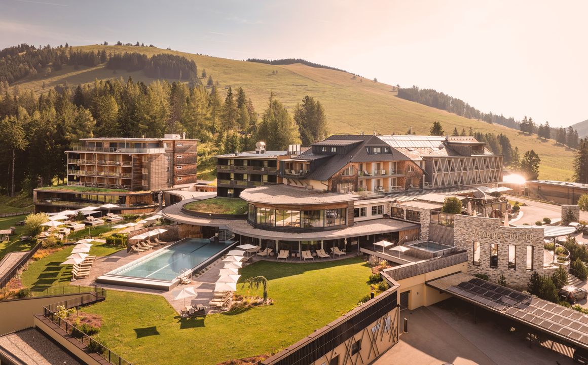 Teichalm – Fladnitz in Austria - a large house with a pool in the middle of it.