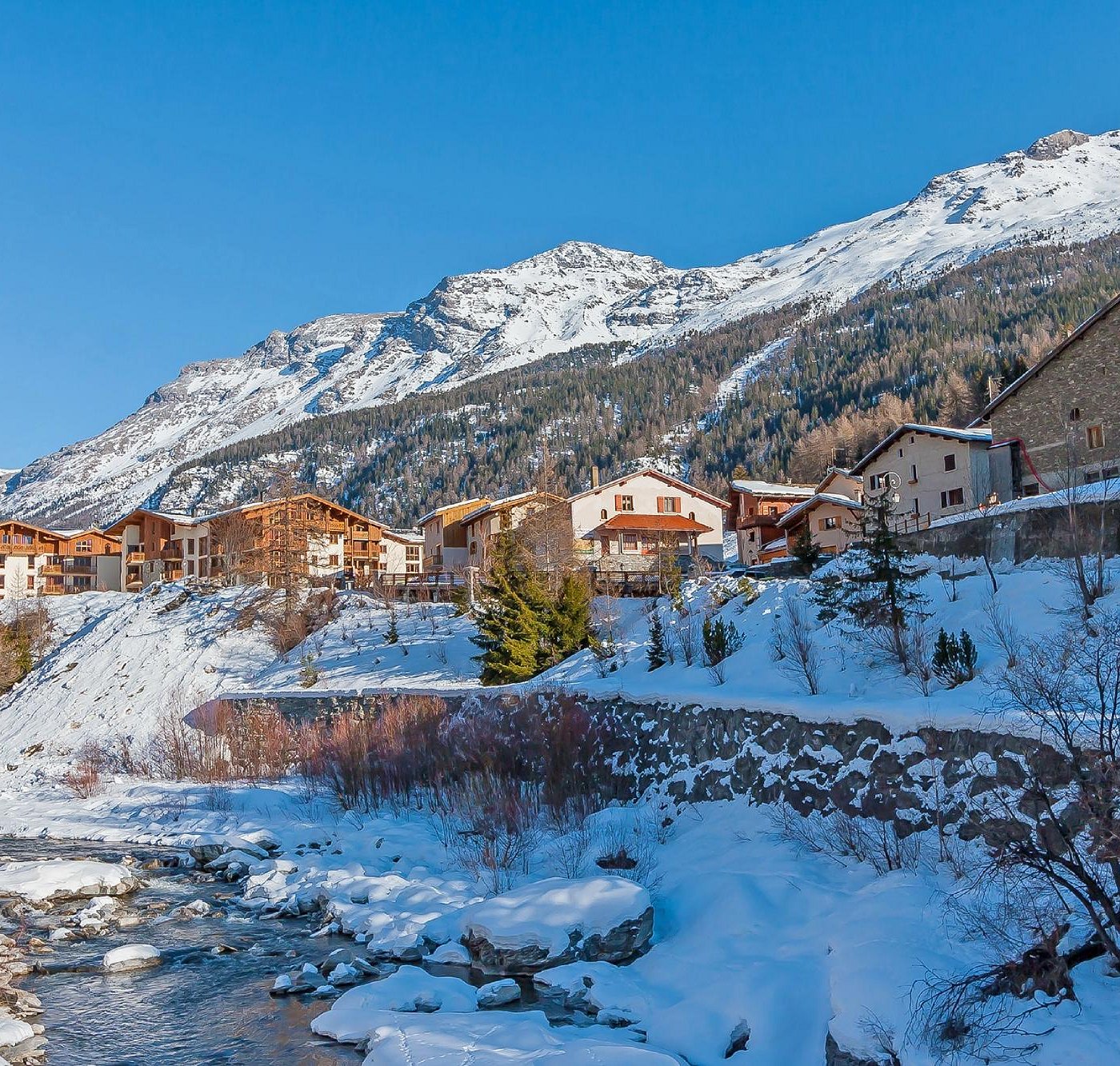 Val Cenis – Lanslevillard | ​Lanslebourg | ​Termignon in France - a river running through a snow covered village.