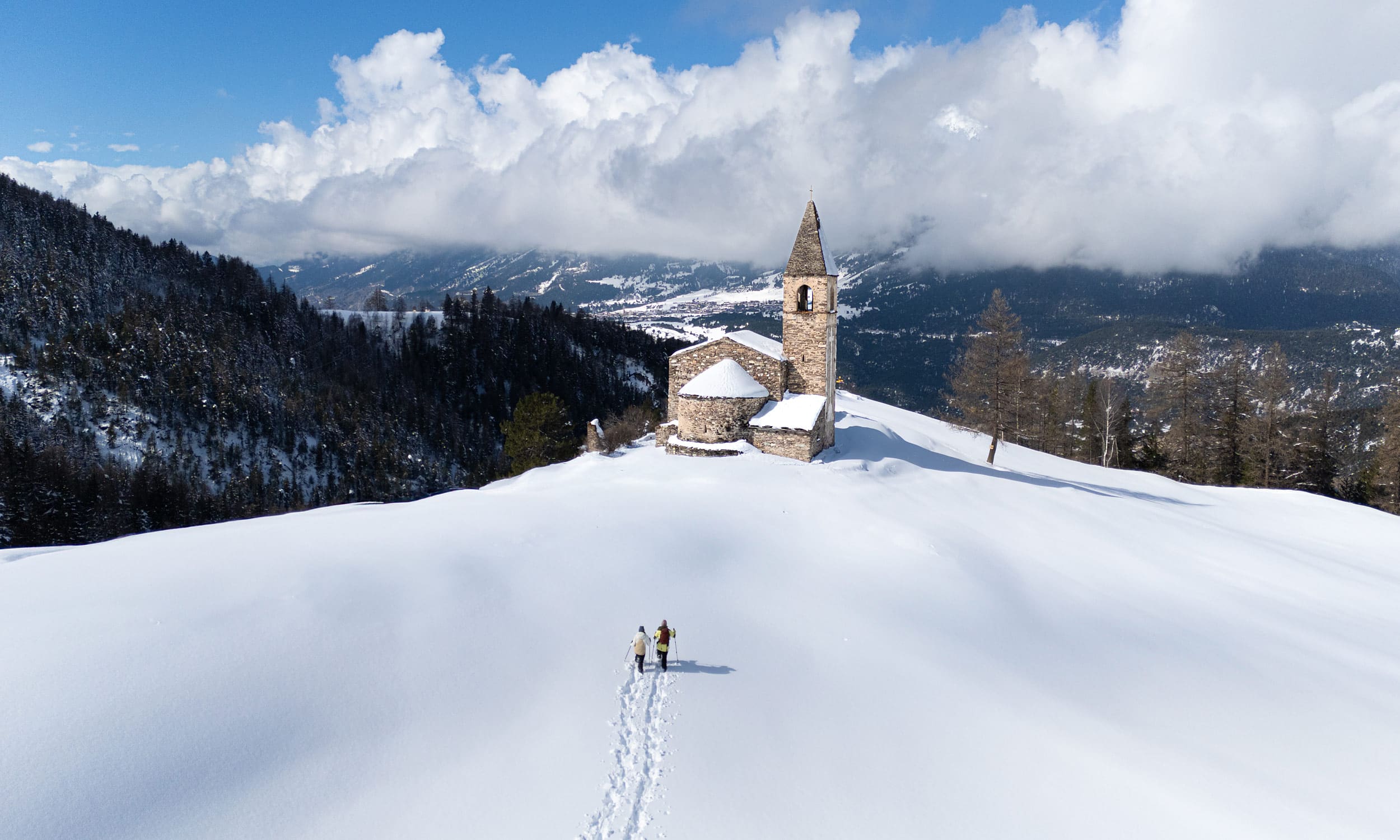 Winter sports scene at Val Cenis in Savoie Mont Blanc, featuring a chalet nestled in breathtaking winter scenery with a majestic snowy mountain backdrop.