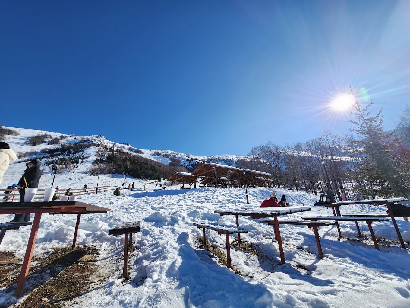 Nizhepole in North Macedonia - a group of people standing on top of a snow covered slope.