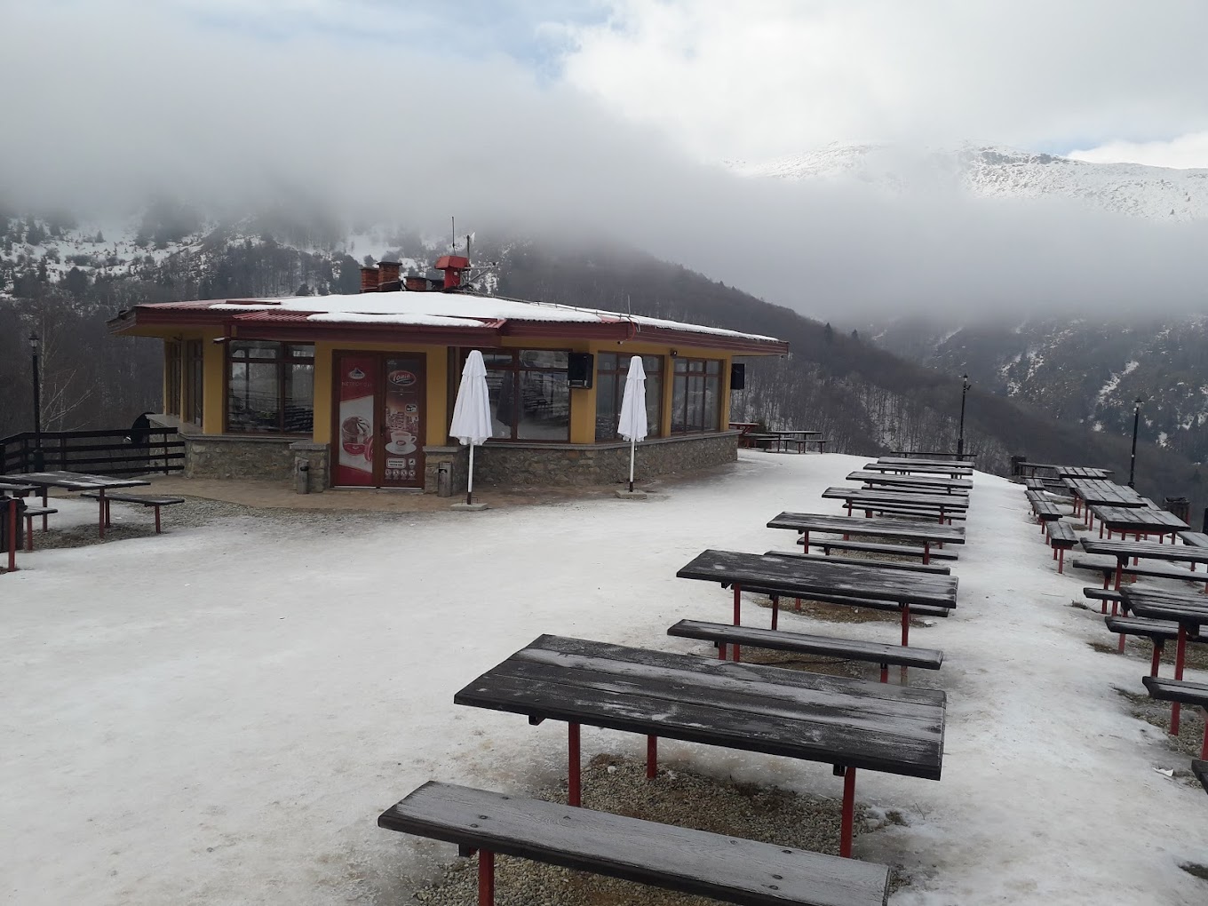 Nizhepole in North Macedonia: a small building with benches and tables in the snow.