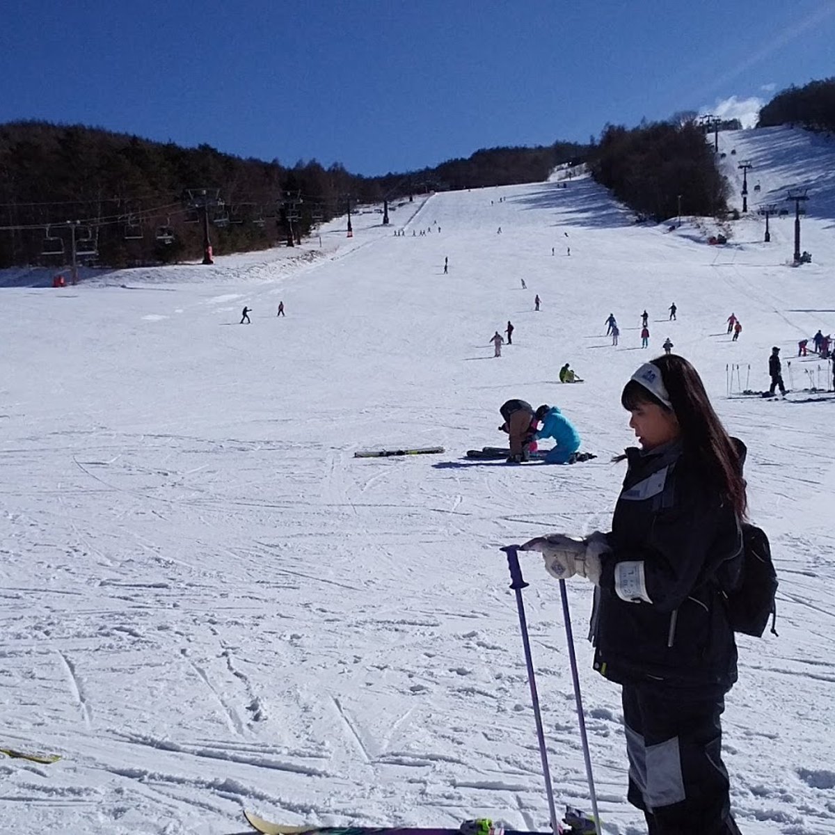 Shirakaba Kogen in Japan - a group of people skiing down a snowy hill.
