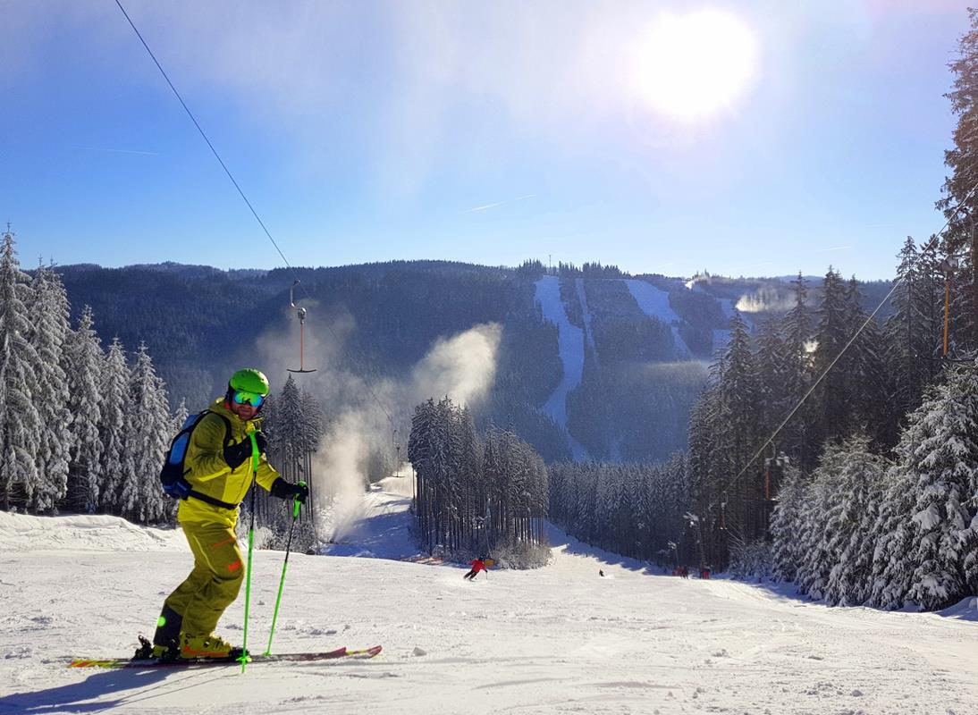 Vranča in Czech Republic - a skier skiing down a slope in the mountains.