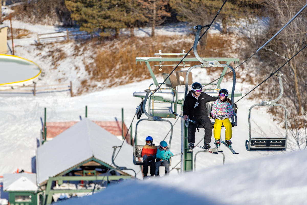 Grand Geneva in USA - a group of people riding a ski lift.