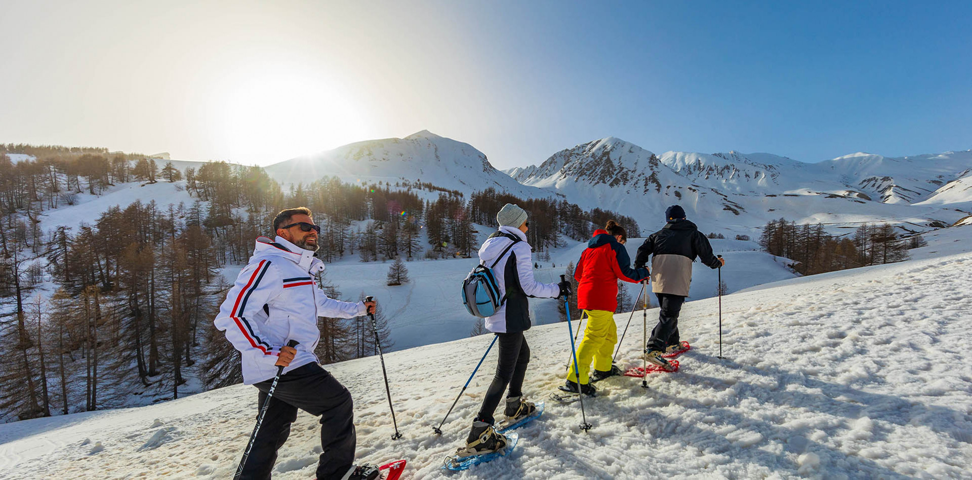 Winter sports scene at Val d'Allos - Espace Lumière in France's Alpes-de-Haute-Provence region, showcasing a group of people, possibly a family, skiing.