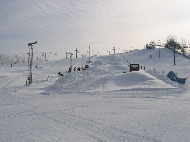 Image of Swiss Valley Michigan showcasing a ski resort complete with a winter sports center ski lift and chalet amid a vibrant winter sports scene.