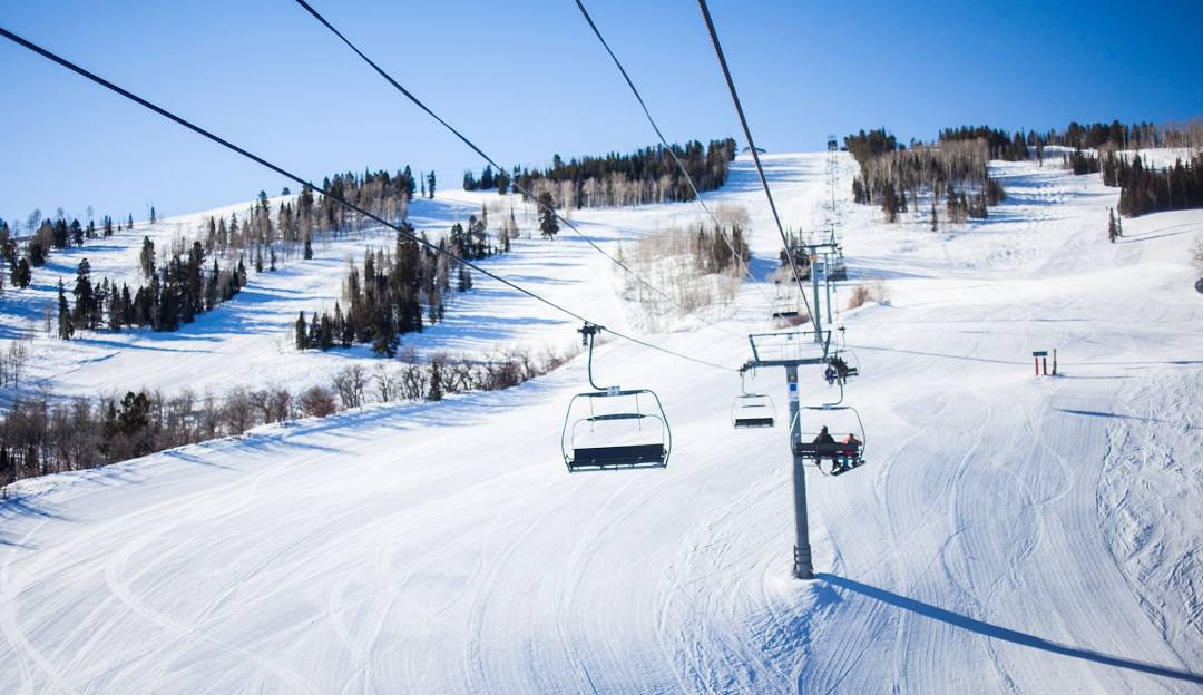 Ski lift at Echo Mountain Park in Idaho Springs, Colorado, highlighting a bustling ski resort with snow-covered slopes and a mesmerizing winter sport scene.