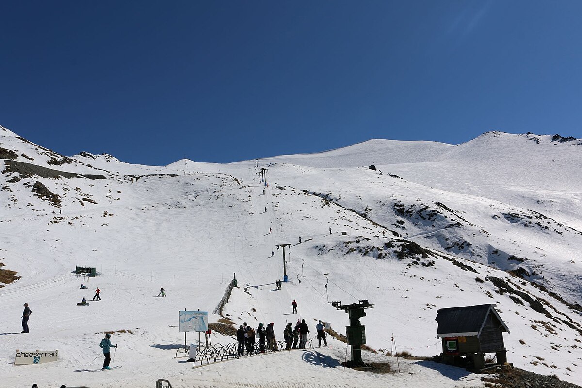 Mt Cheeseman in New Zealand - a group of people standing on top of a mountain.