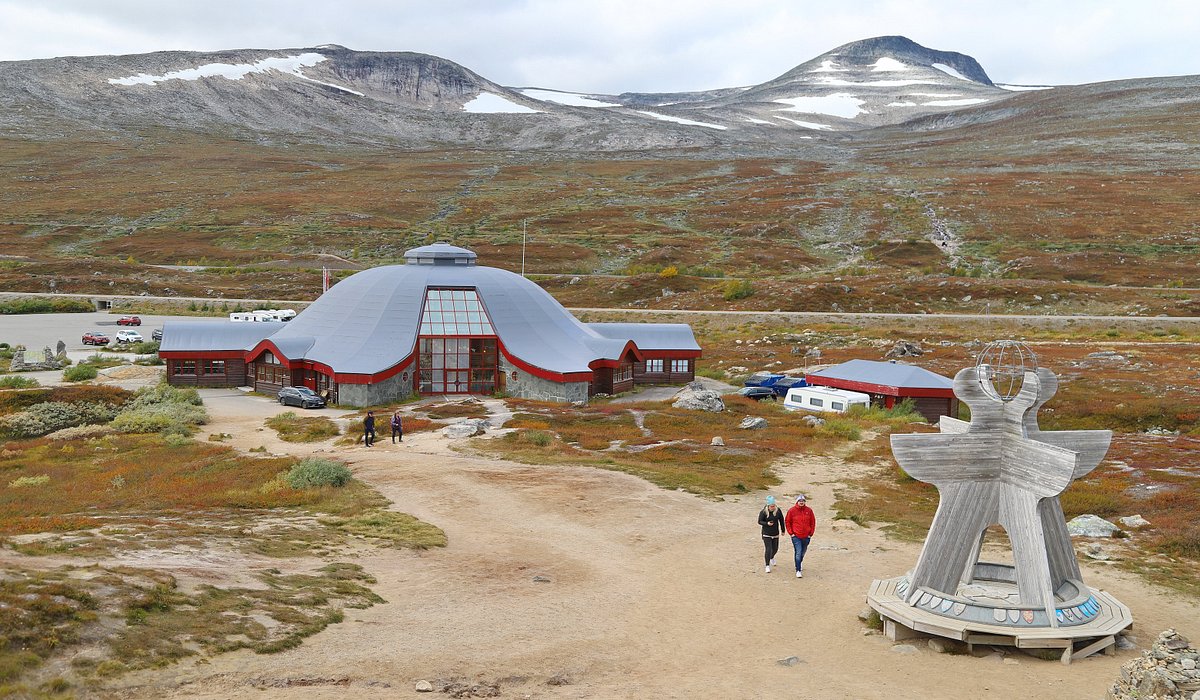 Vestvatn in Norway: a man standing in front of a red and white building.