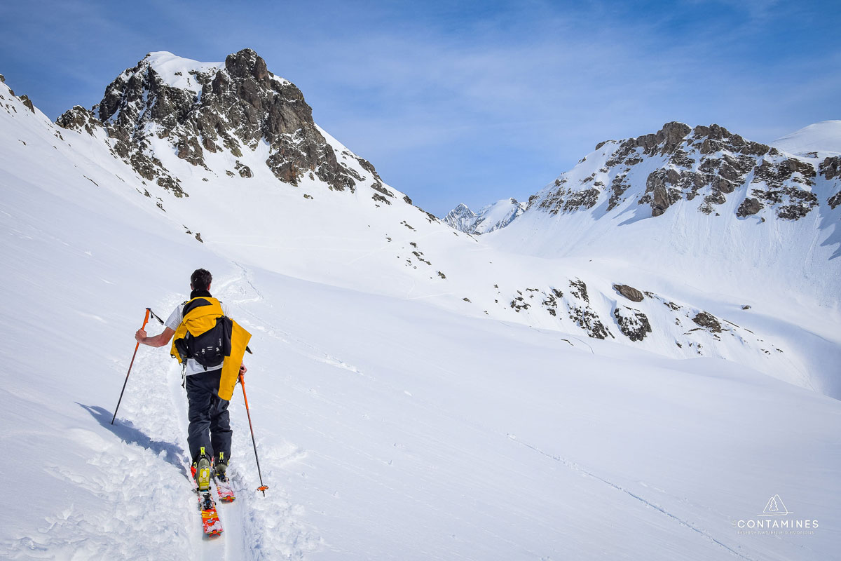 Domaine Skiable des Contamines Montjoie in France - a man is skiing down a snowy mountain.