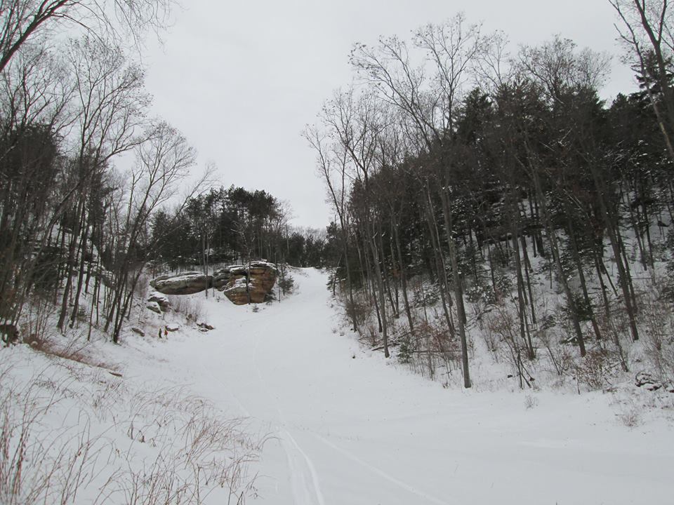 A captivating winter scene at Bruce Mound in Wisconsin showing a bustling winter sports activity. View of a snowmobile suggests adventure in the pristine snow-covered landscape a perfect destination for winter sports enthusiasts.