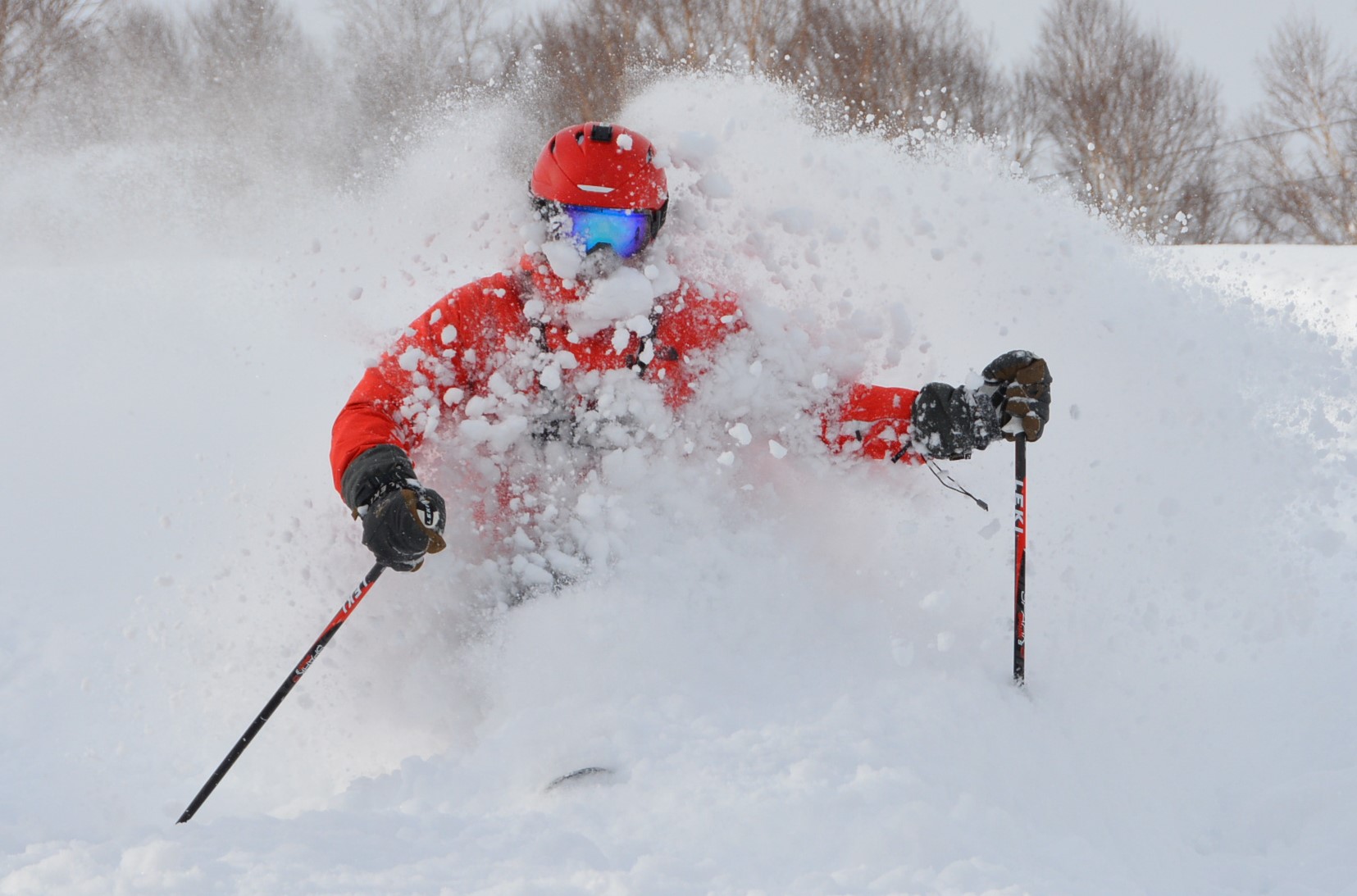Esashicho Mikasayama in Japan - a person in a red jacket skiing down a hill.