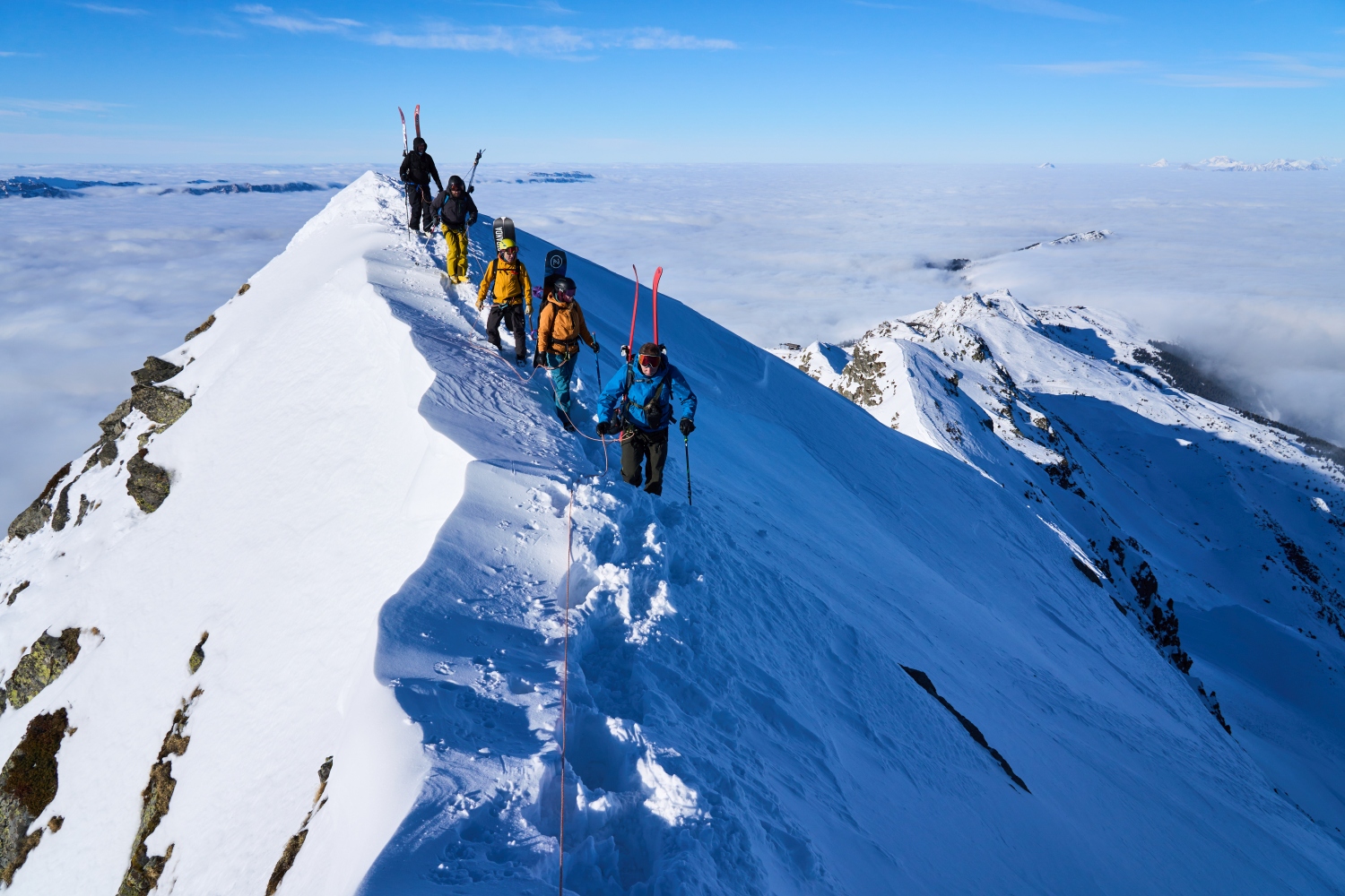 Les Sept Laux in France - a group of people climbing up a snowy mountain.