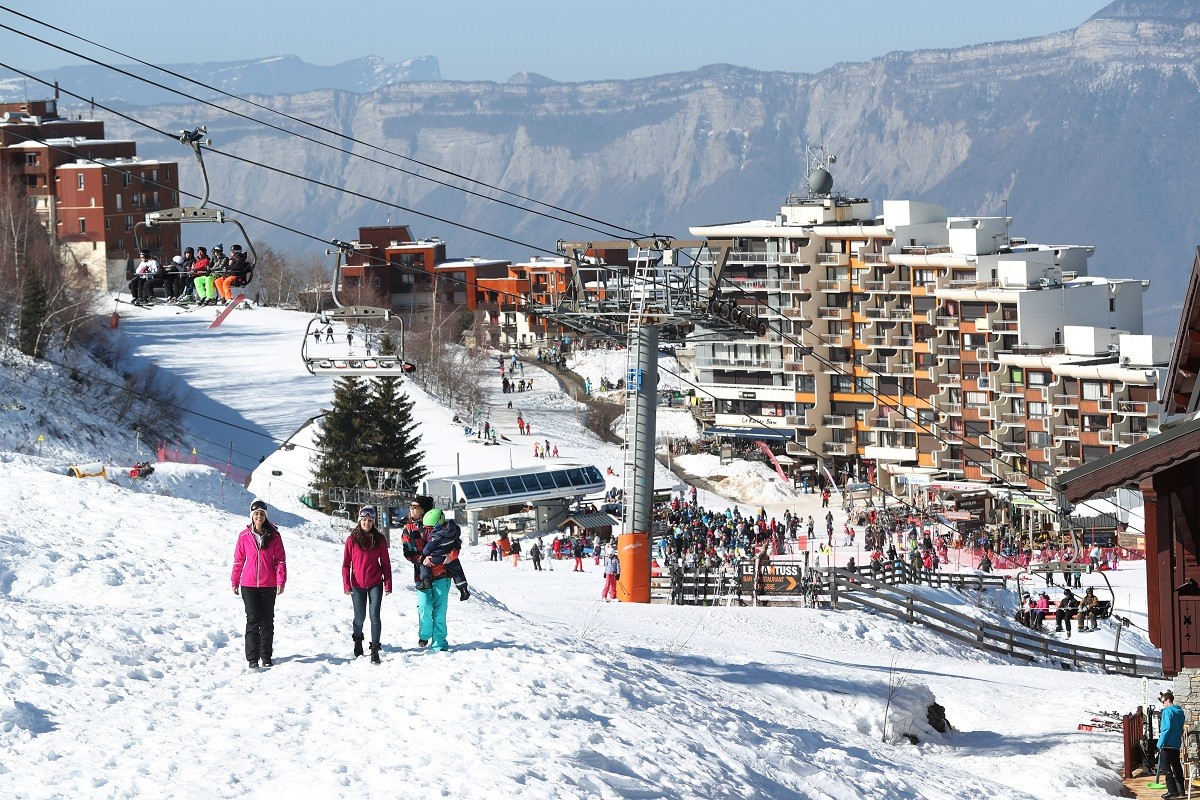 Les Sept Laux in France - a group of people walking down a snow covered slope.