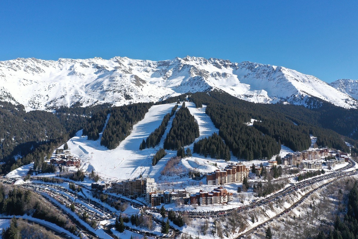 Les Sept Laux in France: a ski resort with snow covered mountains in the background.