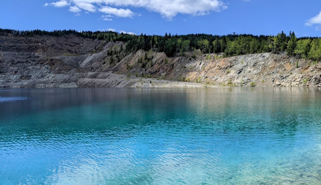 Overlooking a serene lake, nestled in the backdrop of the breathtaking Phoenix Mountain in the Kootenay Rockies, British Columbia, Canada on a sunny day.