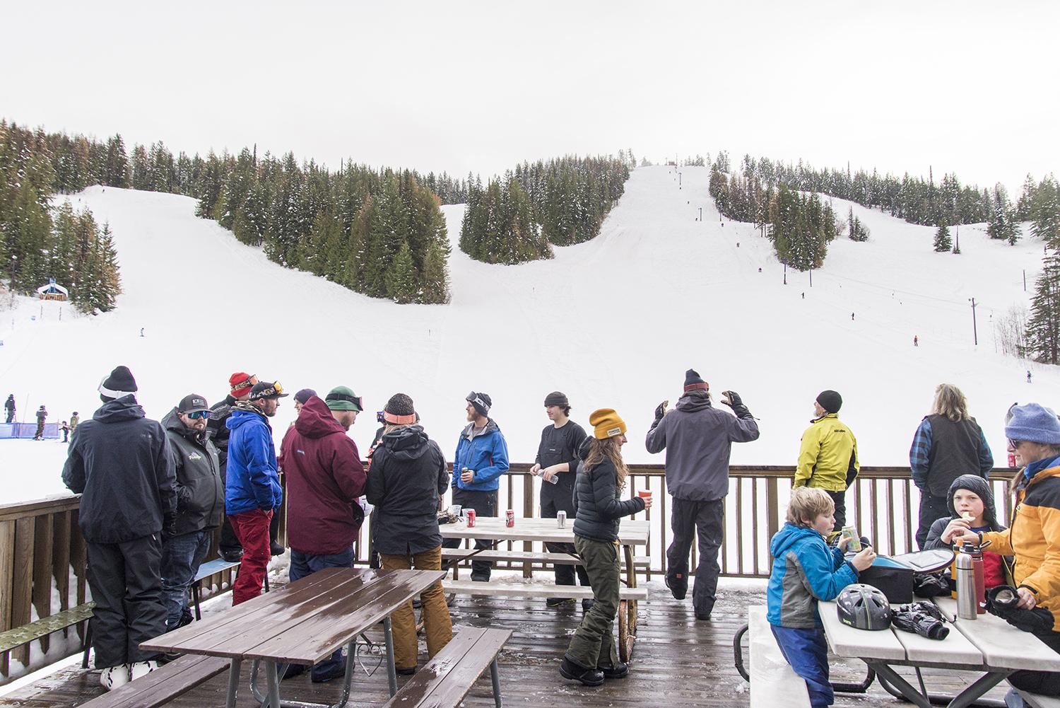 Phoenix Mountain in Canada - a group of people sitting at picnic tables in the snow.