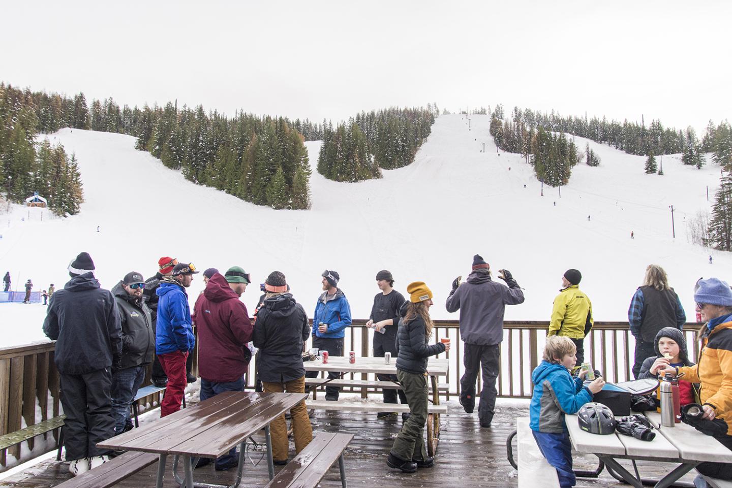 Phoenix Mountain in Canada - a group of people sitting at picnic tables in the snow.