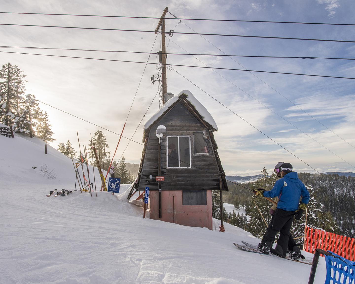 Phoenix Mountain in Canada - a man riding a snowboard down a snowy slope.