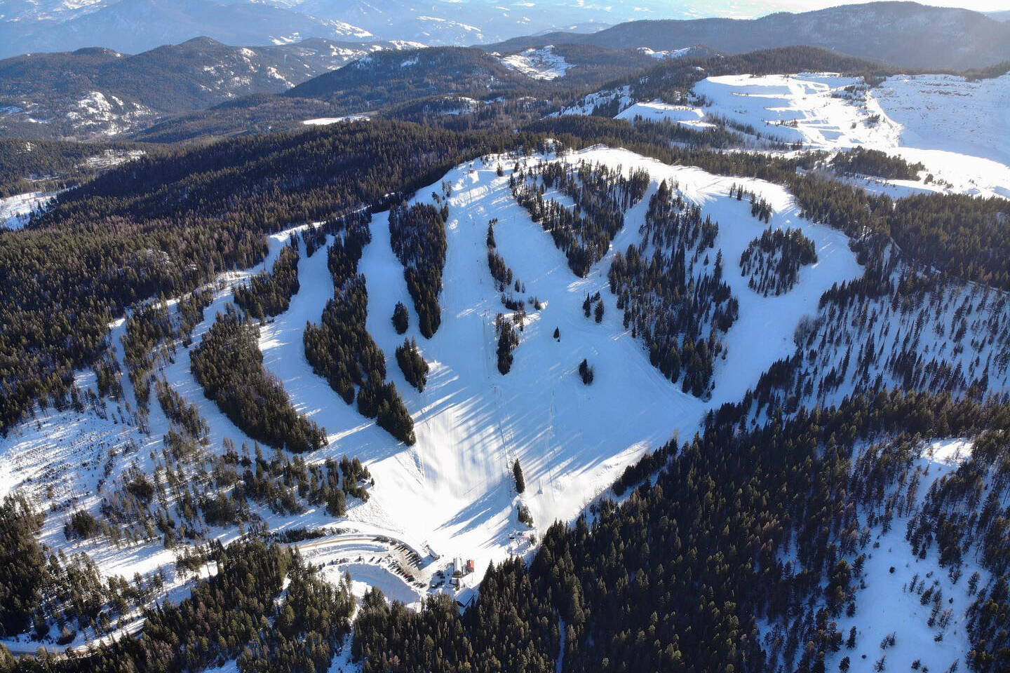 Phoenix Mountain in Canada - a snow covered mountain with trees and mountains in the background.