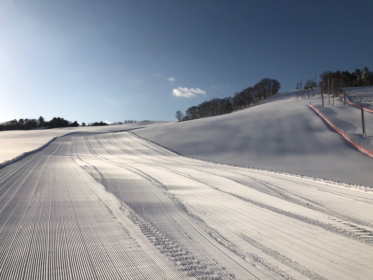 Tendo Kogen in Japan - a ski slope covered in snow on a sunny day.