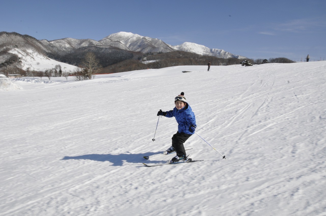 Tendo Kogen in Japan - a man riding skis down a snow covered slope.