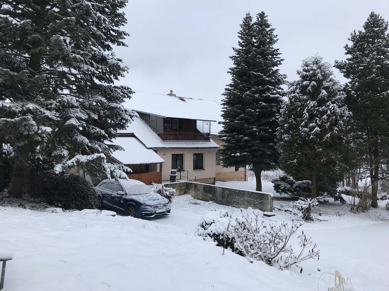 Čerťák – Václavov u Bruntálu in Czech Republic - a car parked in the snow outside of a house.