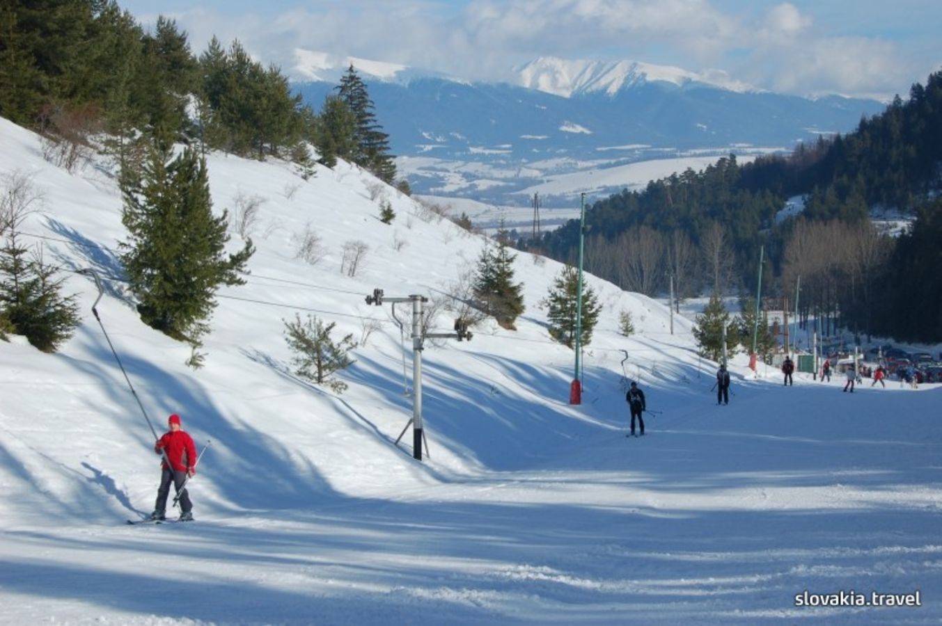 Opalisko – Závažná Poruba in Slovakia - a group of people skiing down a snowy slope.