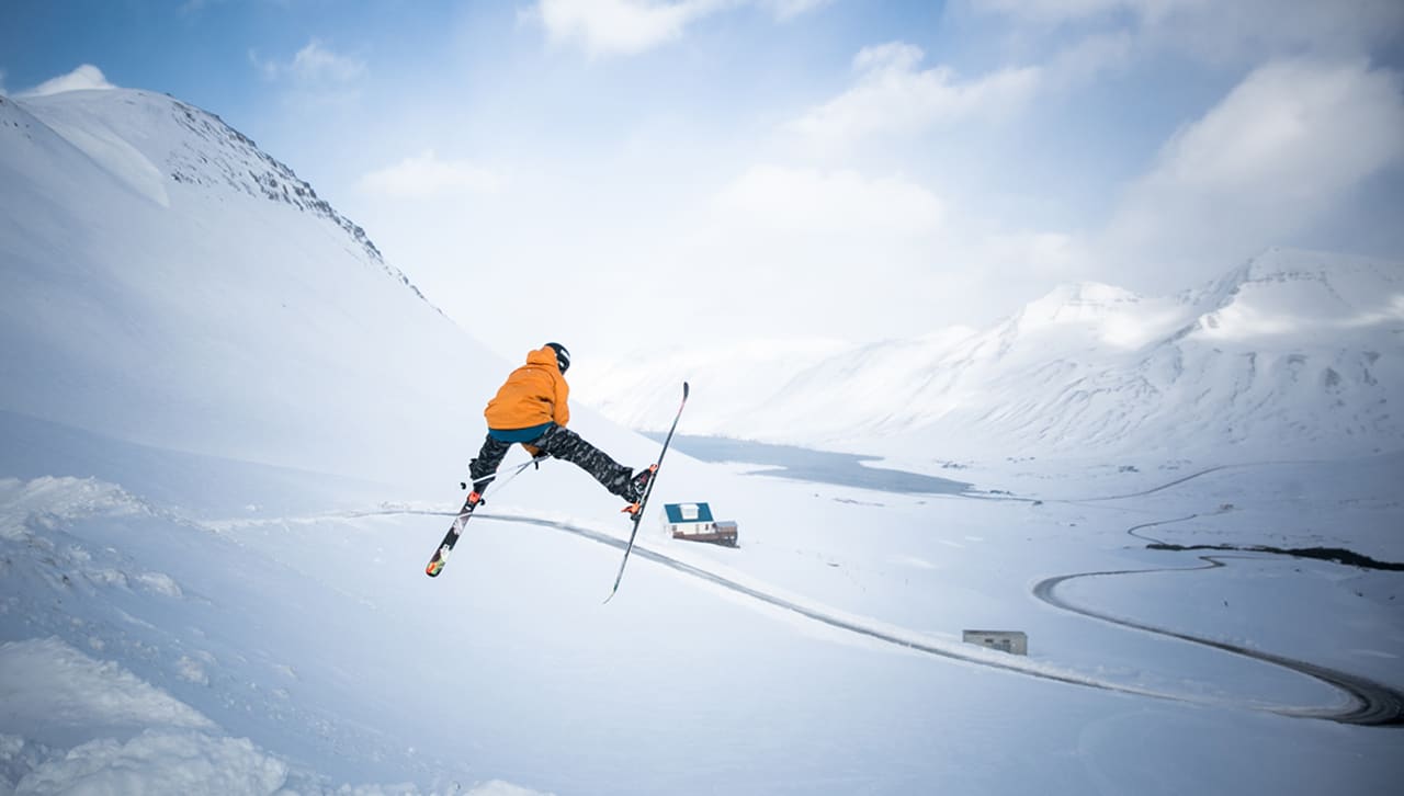 Skarðsdalur – Siglufjörður in Iceland - a person jumping in the air on skis.