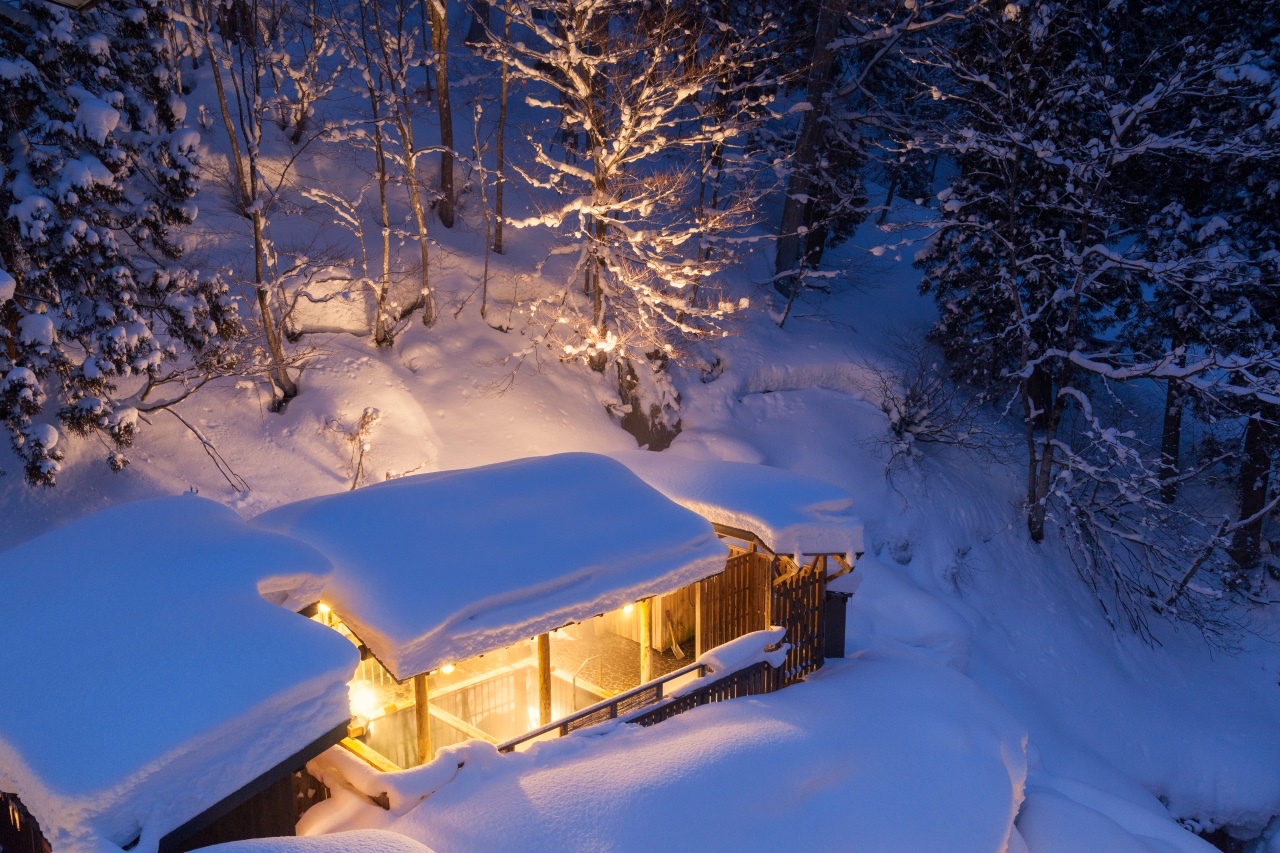 Matsunoyama Onsen in Japan - a cabin in the woods covered in snow.